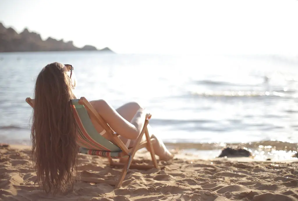 Woman in White Bikini Reclining in Beach Chair
