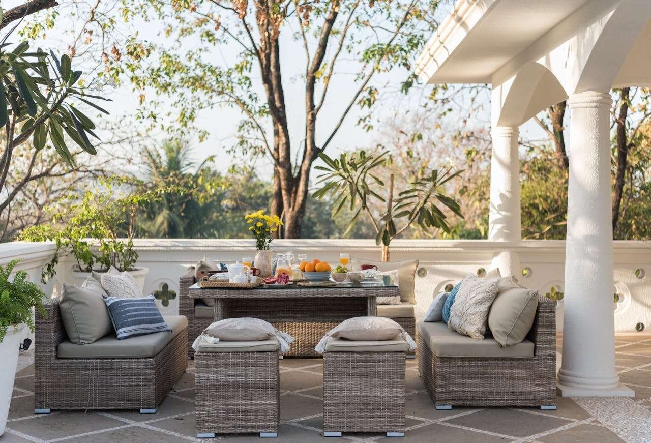 What Makes a Fire Table a Must-Have for Enhancing Your Outdoor Space Outdoor Patio With Brown Wicker Furniture Sofa Set